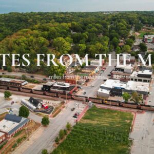 Aerial photo of downtown Parkville, ideal lodging for FIFA 2026 visitors, surrounded by trees with a train passing through the quiet historic district.