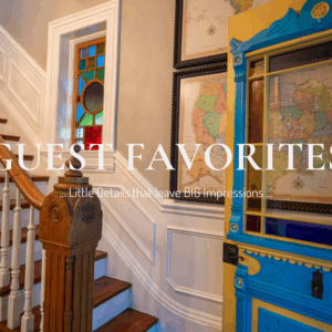 Main Street Inn entryway with staircase, stained glass window, and colorful antique door framed with vintage maps.