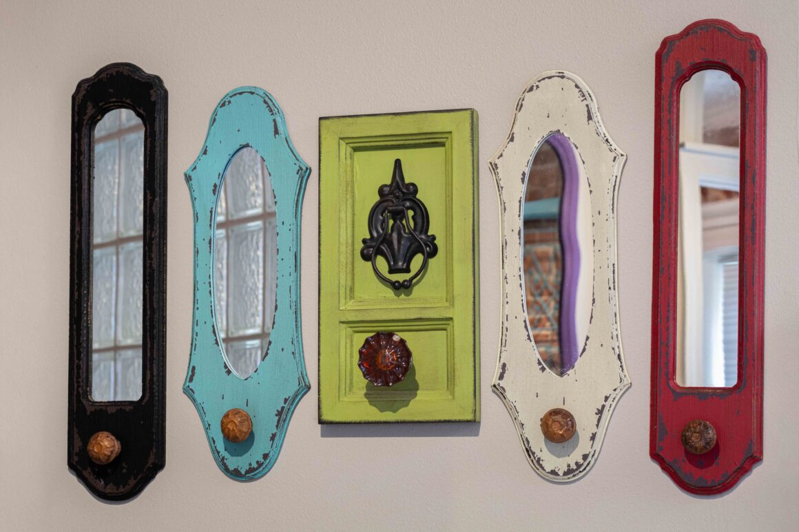 Colorful decorative wall mirrors and hooks inside the Colonel Park Suite.