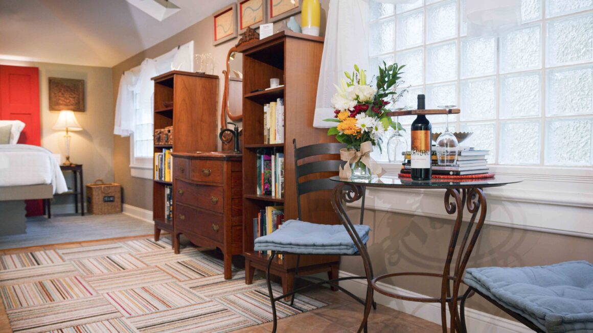 Cozy corner of the Missouri River Suite featuring the bed, window seating, and curated décor - a perfect honeymoon suite in kansas city