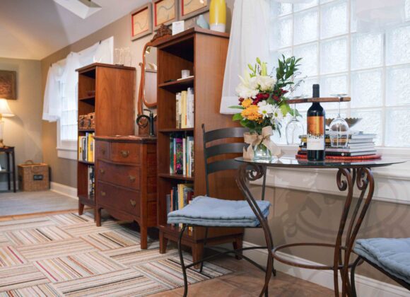Cozy corner of the Missouri River Suite featuring the bed, window seating, and curated décor - a perfect honeymoon suite in kansas city