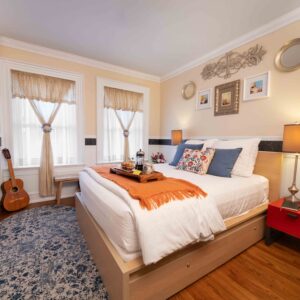 Romantic bed and breakfast room with a vintage fireplace and warm candlelight in Old Kate’s Room at Main Street Inn.