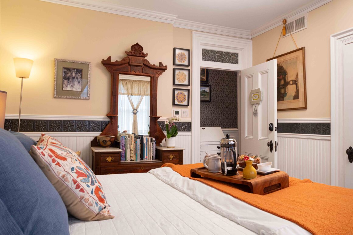 Vintage dresser with books and décor inside Old Kate’s Room at the Main Street Inn.