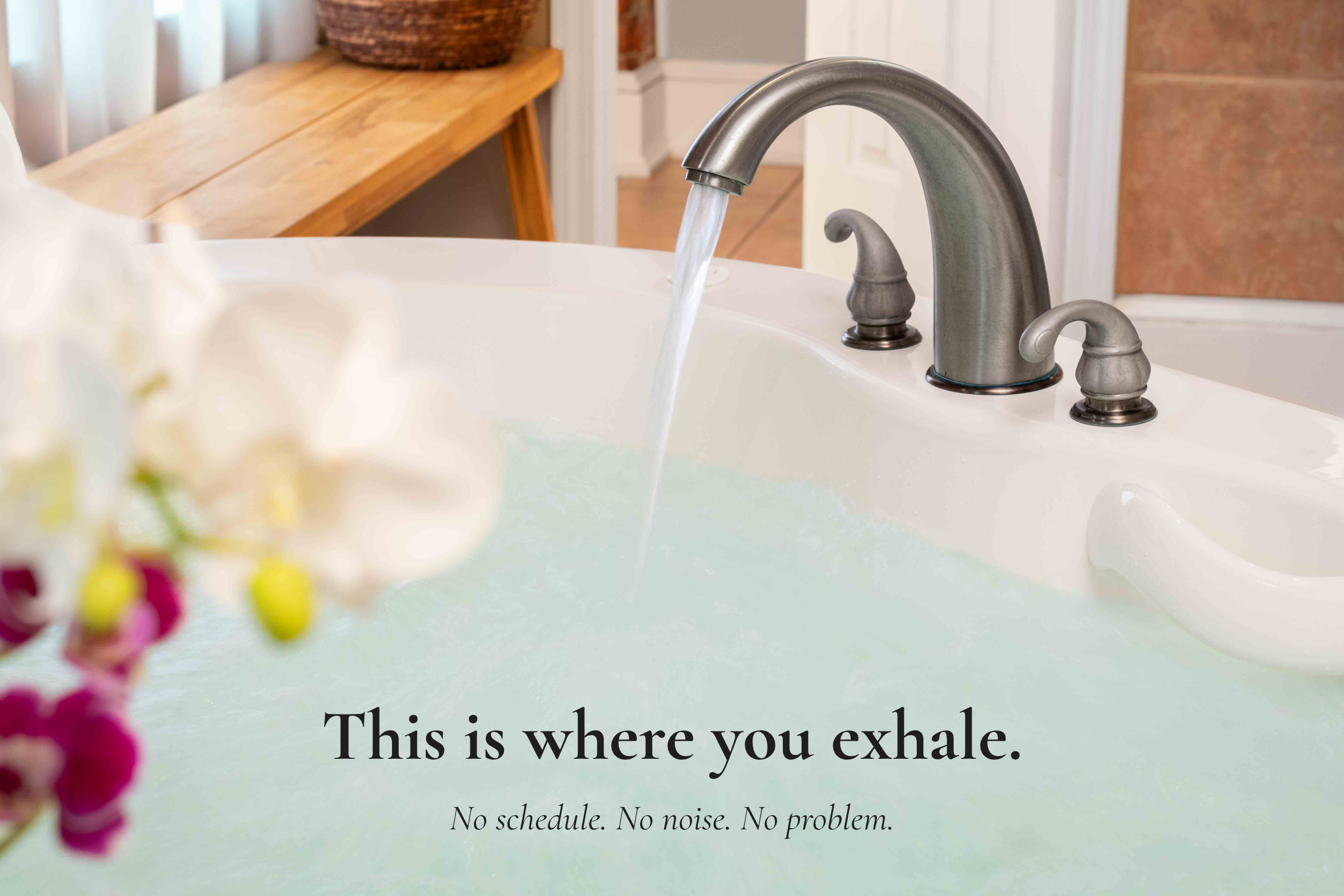 Soaking tub filling with water in Main Street Inn bathroom for a relaxing stay