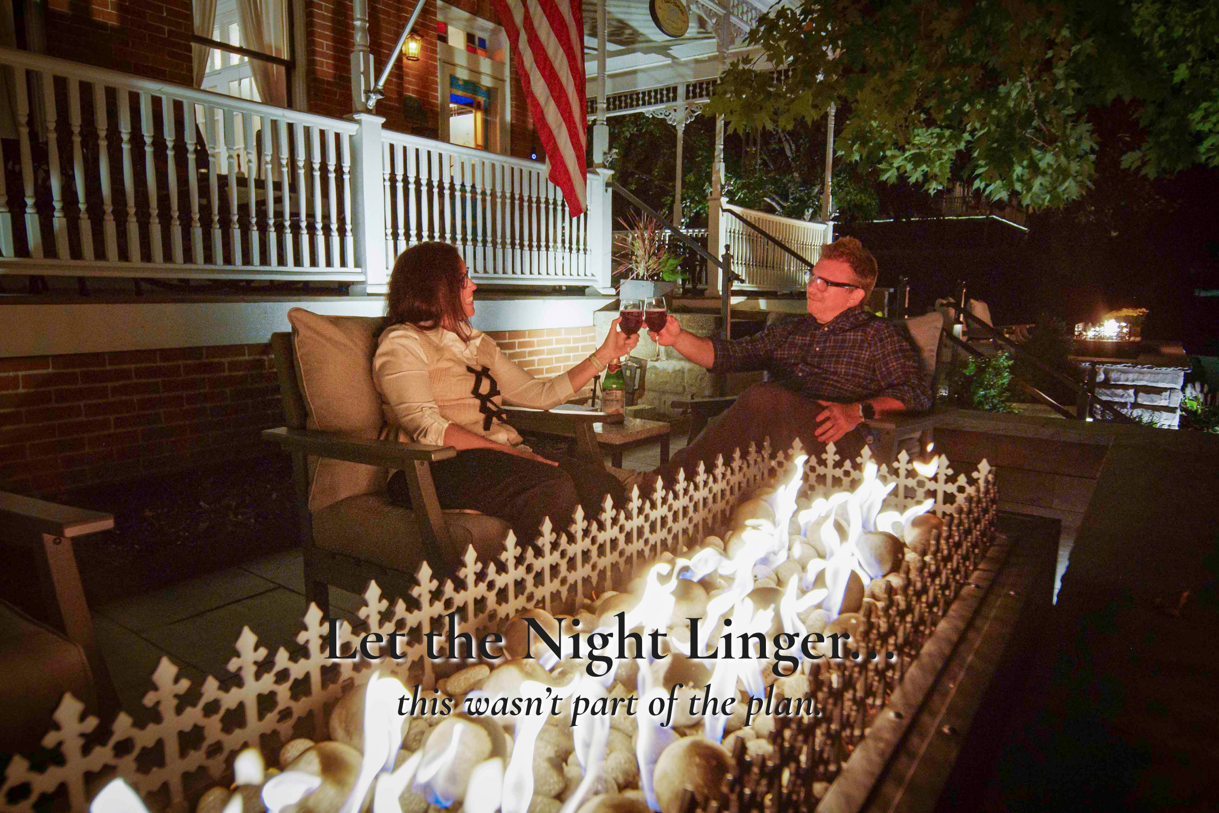 Couple relaxing by the fire pit at Main Street Inn after an evening near Morton Amphitheater