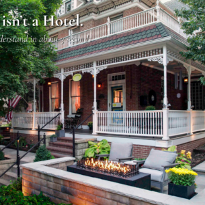 Main Street Inn exterior in Parkville Missouri with front porch and fire feature at dusk