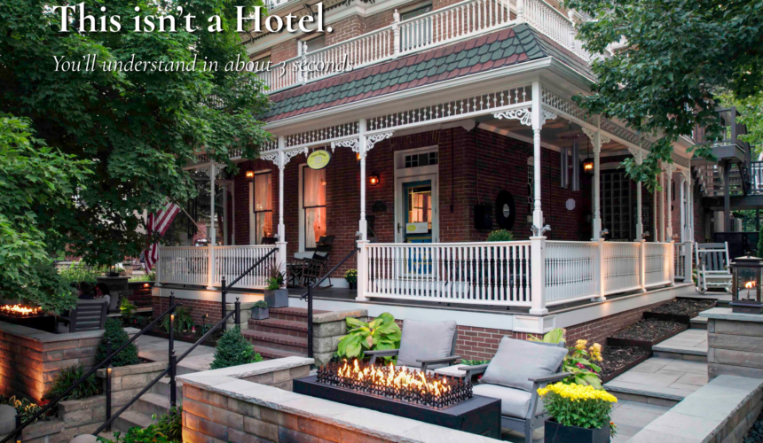 Main Street Inn exterior in Parkville Missouri with front porch and fire feature at dusk